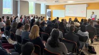 Karl Baldacchino presenting to a full audience in IRR south seminar room