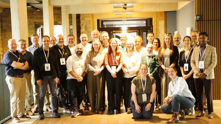 A group photo of participants standing and smiling at the camera