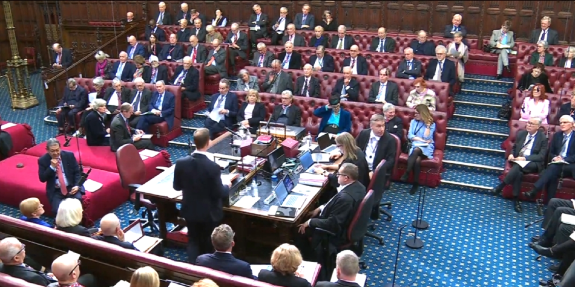 Inside the House of Lords. A room with peers on opposite sides of the room, separated by a table in the middle