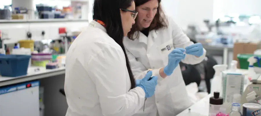 intern in discussion with supervisor in lab