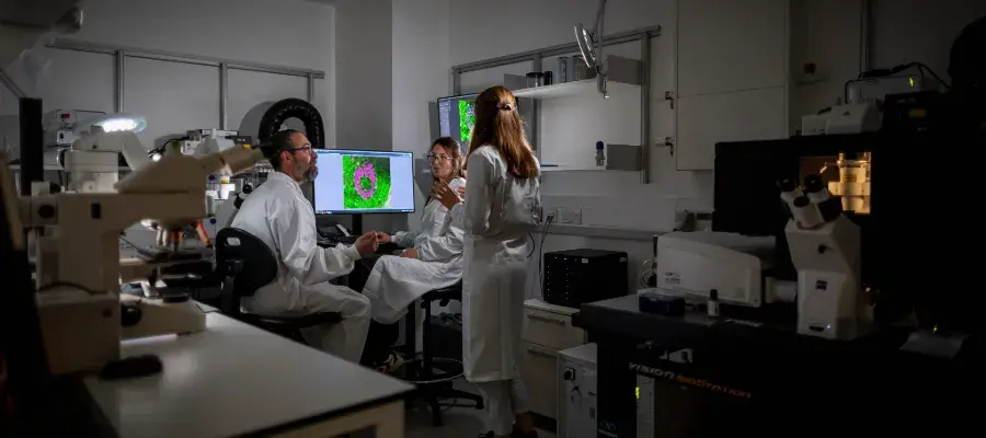 researchers in specialist imaging suite looking at micrscopy on display
