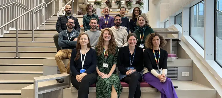 Walmsley lab group members sit on steps within IRR