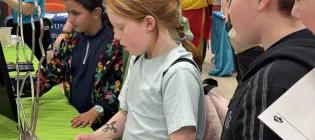 Children playing circuit buzzer game at Doors Open Day event
