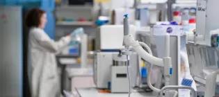 lab equipment in the lab. In the backgrounda scientist works on an experiment