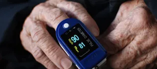 Device that measures blood oxygen levels on the finger of an elderly individual