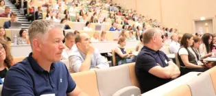Audience members listen to presentations at the IRR Symposium 2026