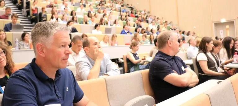 Audience members listen to presentations at the IRR Symposium 2026