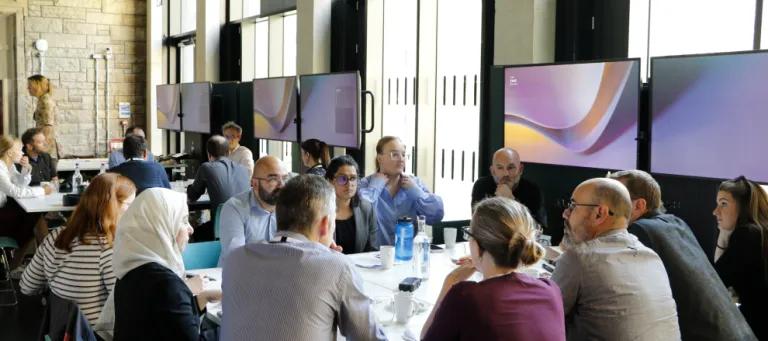 A group of participants in discussion around a table