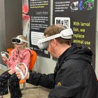 Father and daughter using VR headsets