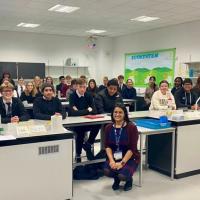 High school children posing for photo in classroom