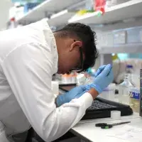 an intern using a pipette in the lab