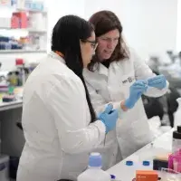 intern in discussion with supervisor in lab