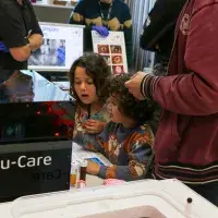 Two children looking at the uCare exhibit