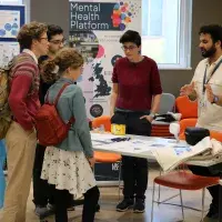 Volunteers explaining their mental health platform to public