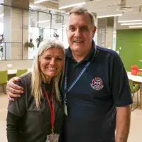 Two volunteers hugging for the camera
