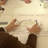 Man drawing on a poster "bungalow bliss"