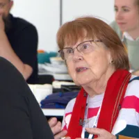 Woman mid-sentence, in conversation with someone