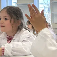 Two children at a table, playing with play dough