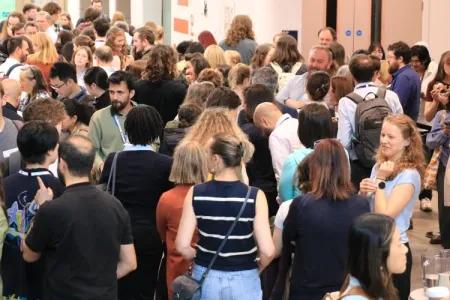 Symposium attendees networking during a break
