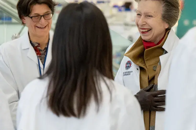 The Princess Royal and a few women wearing lab coats on a facility tour