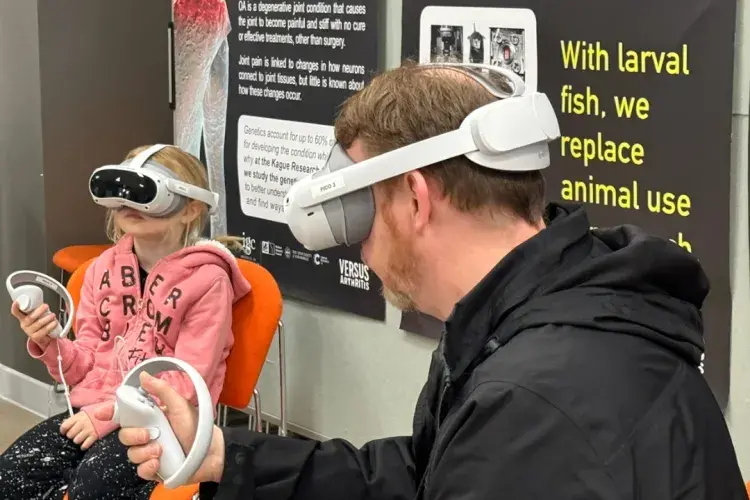 Father and daughter using VR headsets