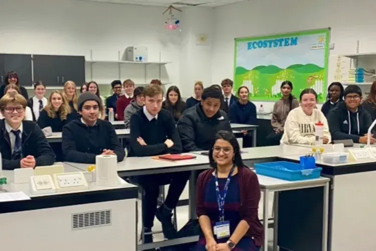 High school children posing for photo in classroom