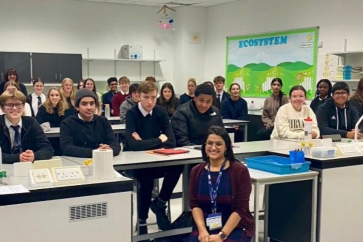 High school children posing for photo in classroom