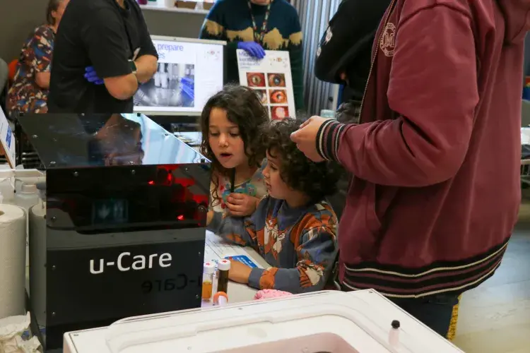 Two children looking at the uCare exhibit