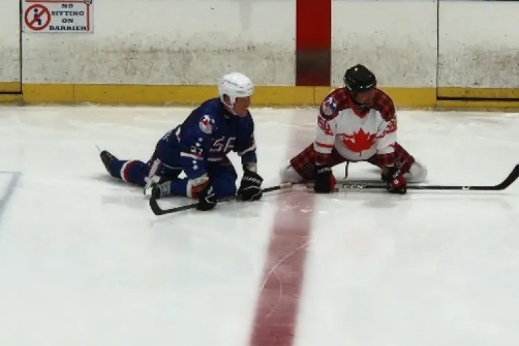 Two ice hockey players kneeling on the ice