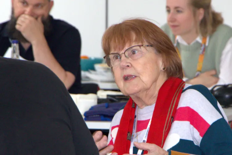 Woman mid-sentence, in conversation with someone