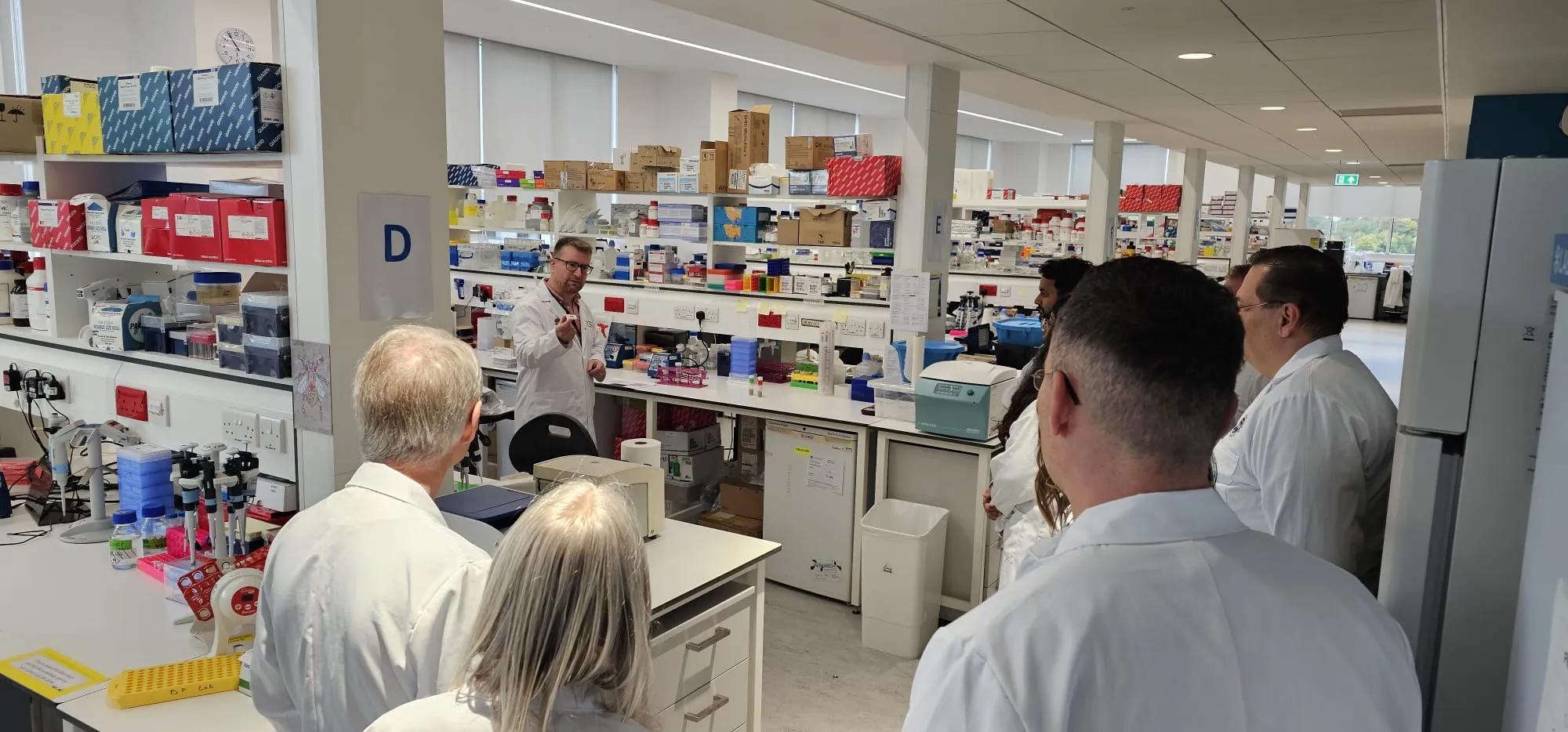 A small group of people wearing lab coats in an IRR lab