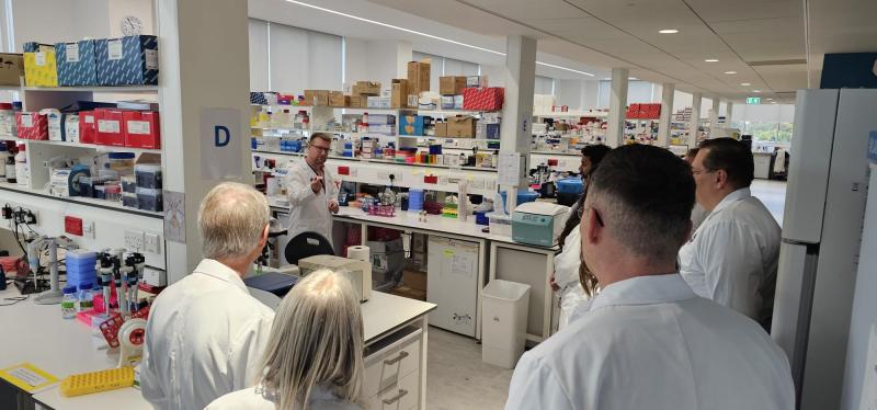 A small group of people wearing lab coats in an IRR lab