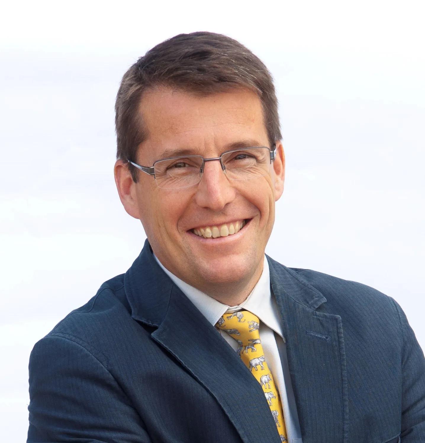 Stephen Gordon wearing a grey suit and smiling