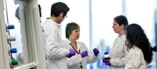 studentds and teacher in conversation in the lab