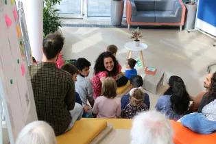 Rana speaking into a microphone, speaking to the audience