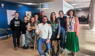Group photo of the Walmsley lab, with Manuel in the middle holding up a celebratory glass