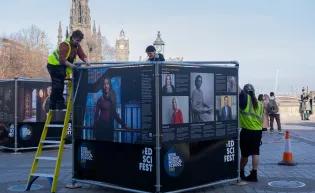Workers build the frame of one of the exhibition squares