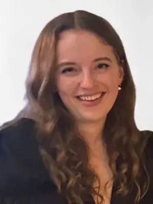 Emily is smiling at the camera