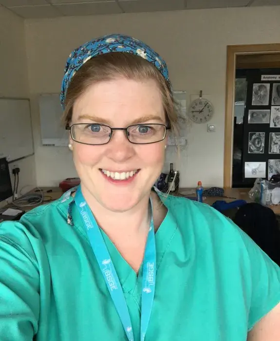 Lucy whitaker taking a selfie wearing teal scrubs